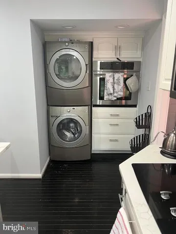 a utility room with sink dryer and washer