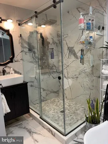 a bathroom with a shower and a sink