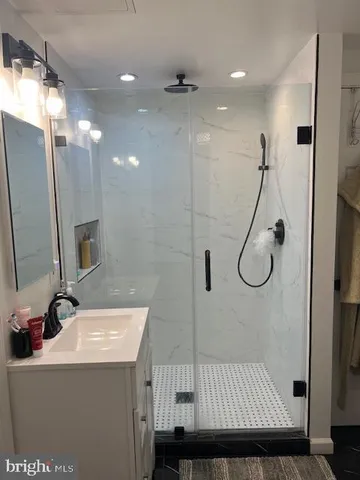 a bathroom with a sink and mirror with toilet