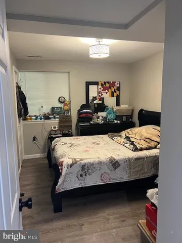 a bedroom with a bed and a mirror