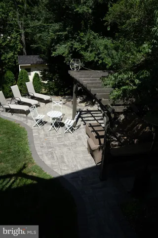 a front view of a house with a garden and trees