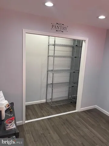 a view of room with wooden floor