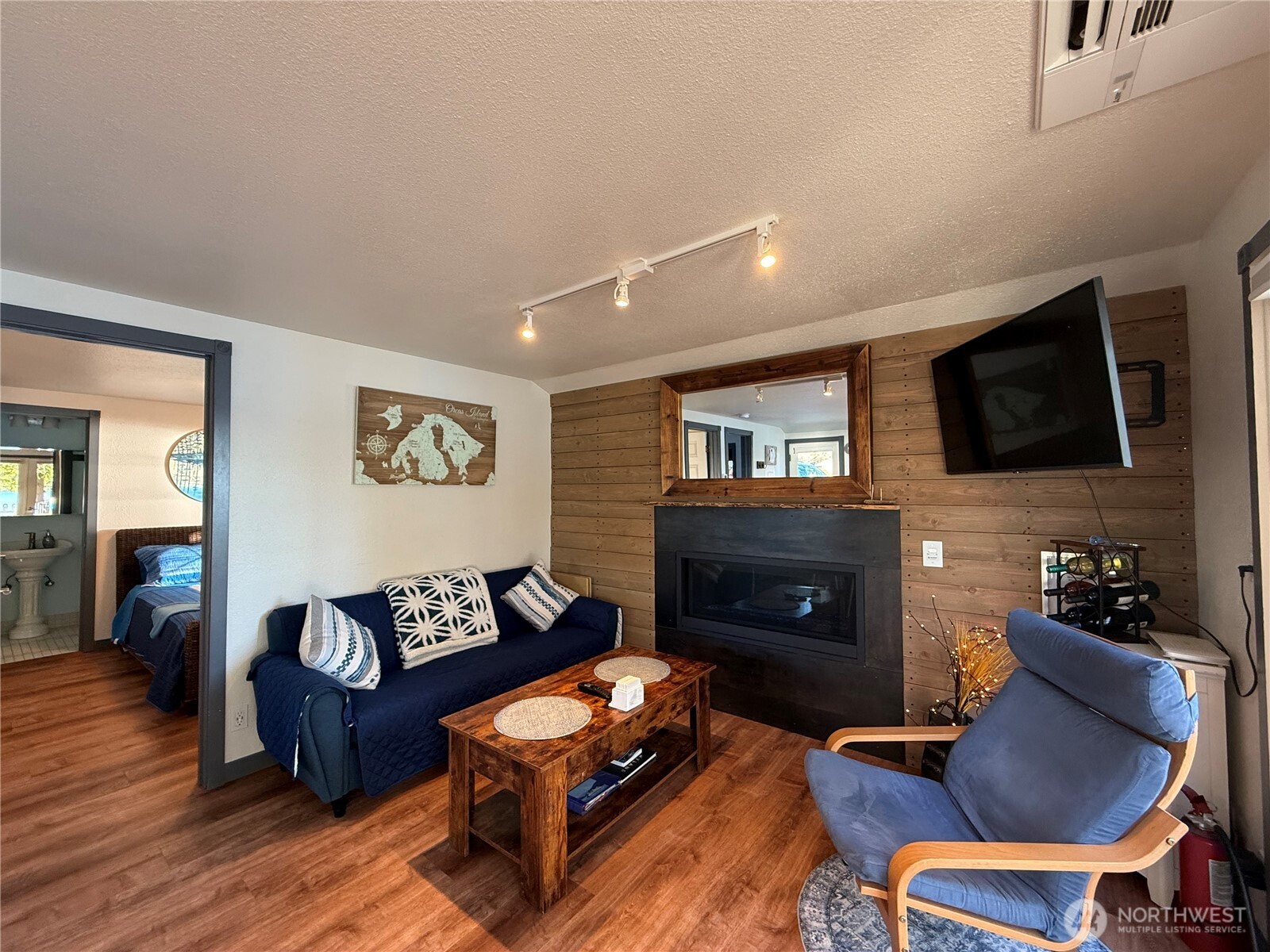 5244 Deer Harbor Road Orcas Island, WA 98243 - Photo 24 of 38 a living room with furniture a flat screen tv and a fireplace