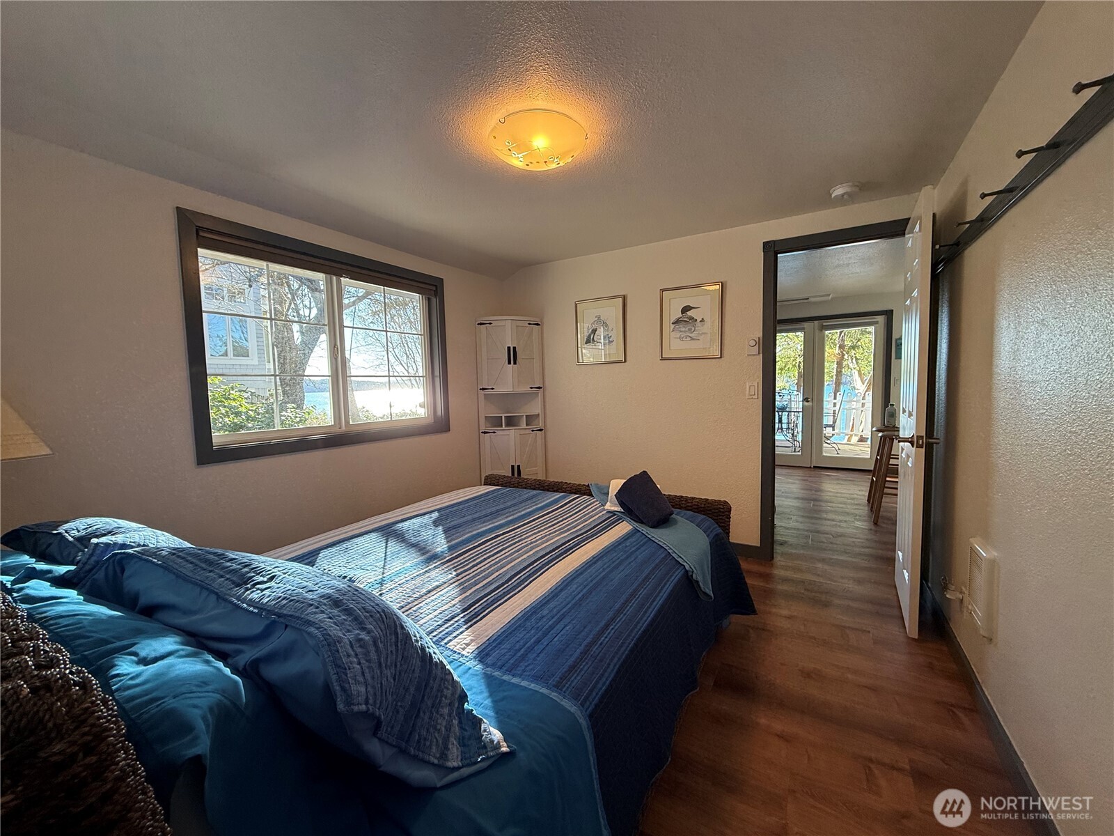 5244 Deer Harbor Road Orcas Island, WA 98243 - Photo 32 of 38 a bedroom with a bed and a lamp next to a window