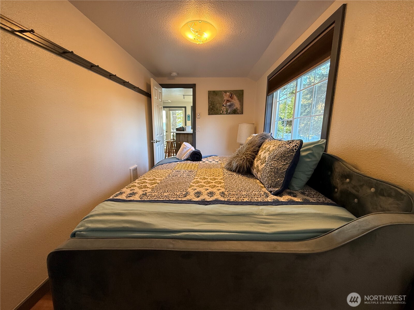 5244 Deer Harbor Road Orcas Island, WA 98243 - Photo 34 of 38 a bedroom with a bed and wooden floor