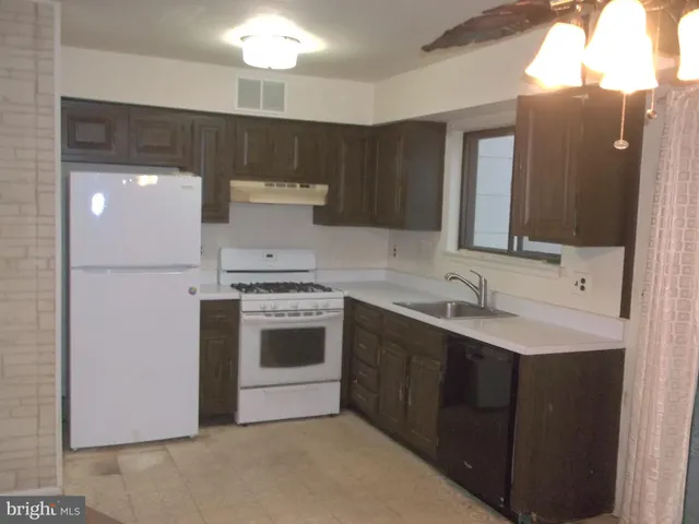 a kitchen with a sink cabinets and stainless steel appliances
