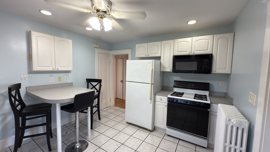 70 Union Street, Unit 2 Boston, MA 02135 - Photo 2 of 17 a kitchen with stainless steel appliances a stove a sink refrigerator and a refrigerator