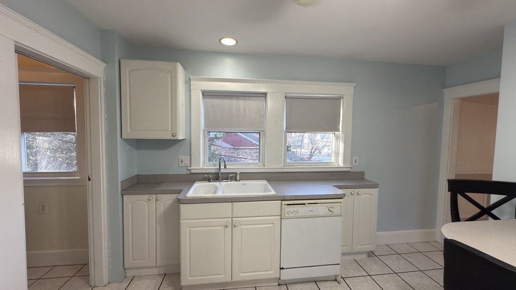 70 Union Street, Unit 2 Boston, MA 02135 - Photo 3 of 17 a kitchen with white cabinets and sink
