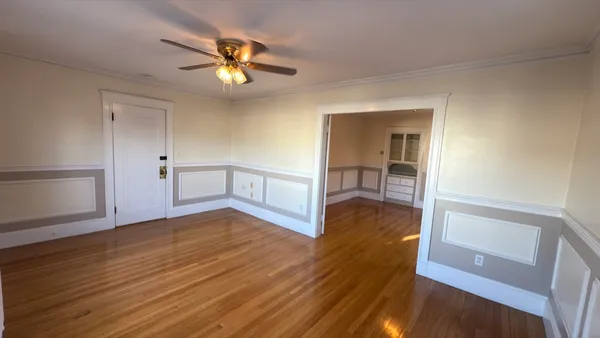 a view of an empty room and wooden floor