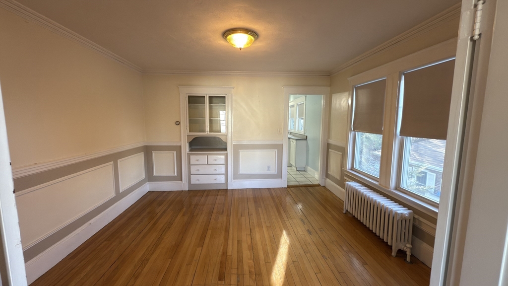 70 Union Street, Unit 2 Boston, MA 02135 - Photo 9 of 17 a view of an empty room with wooden floor and a window