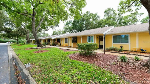 a front view of a house with a yard table and chairs