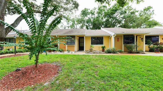 a front view of house with yard and green space