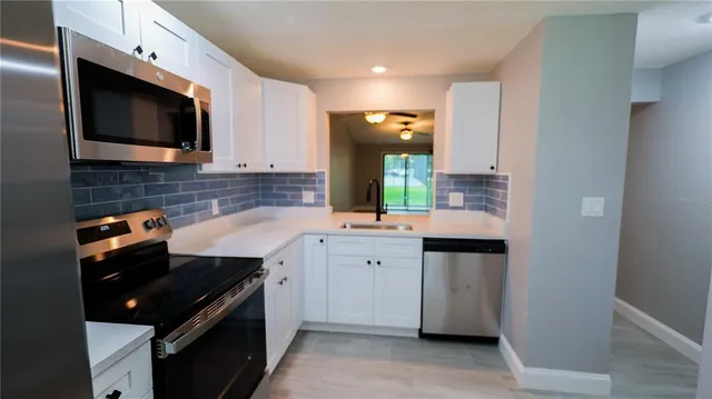 a kitchen with a sink stove and microwave