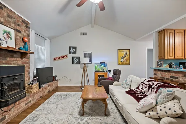 a living room with furniture a rug and a fireplace