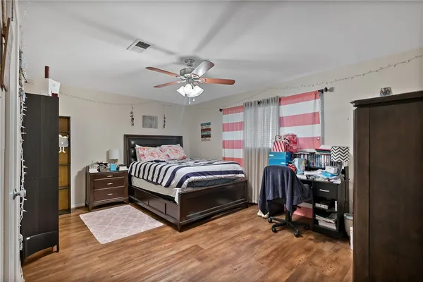 a bedroom with a bed and a chandelier