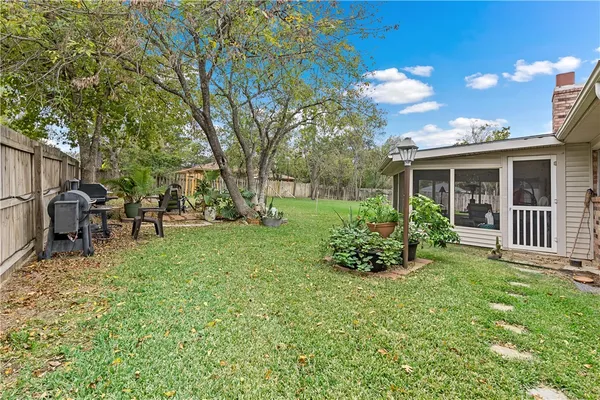 a view of a house with backyard sitting area and garden