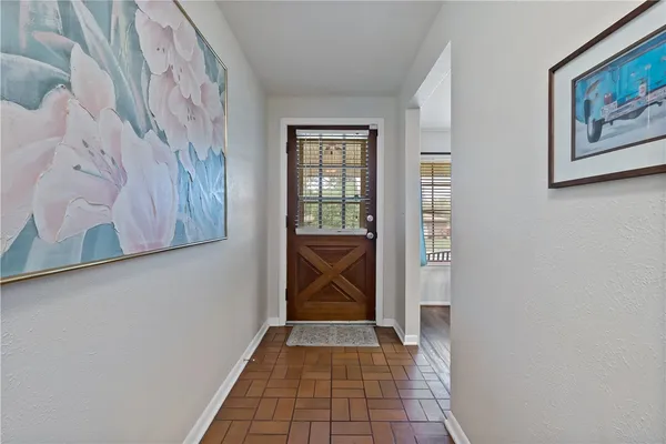 a view of a hallway with paintings on the wall