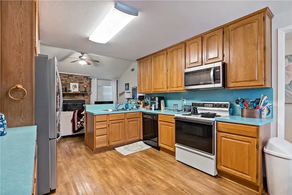 a kitchen with stainless steel appliances granite countertop a stove and cabinets