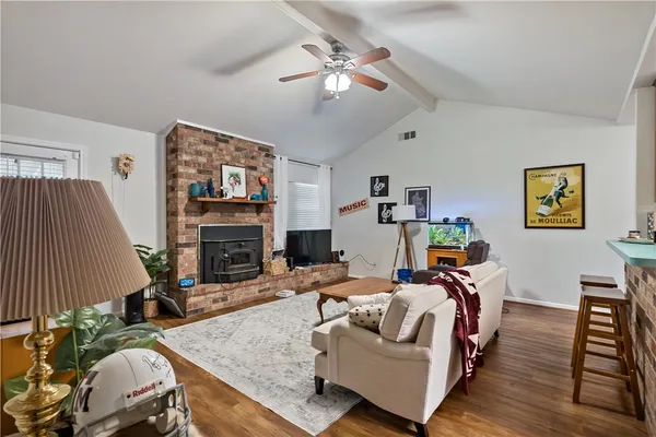 a living room with furniture a fireplace and a flat screen tv
