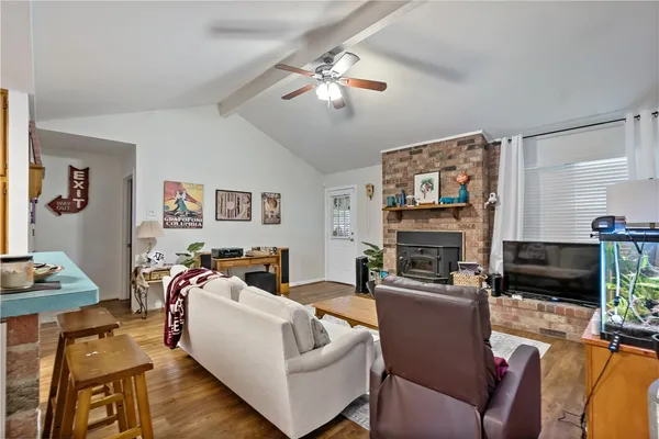 a living room with furniture a flat screen tv and a fireplace