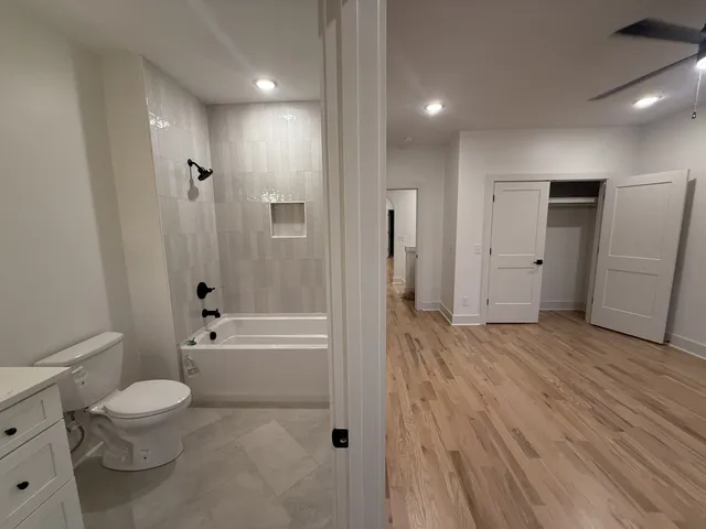 a bathroom with a toilet a sink and bathtub