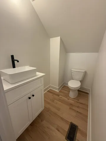a bathroom with a sink a toilet and a mirror
