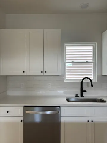 a kitchen with a sink and cabinets
