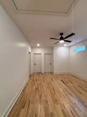 a view of an empty room and wooden floor