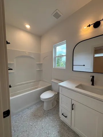 a bathroom with a toilet a sink and a bathtub