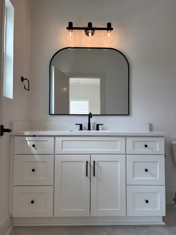 a bathroom with a sink and a mirror