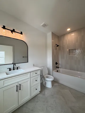 a bathroom with a toilet and a bathtub