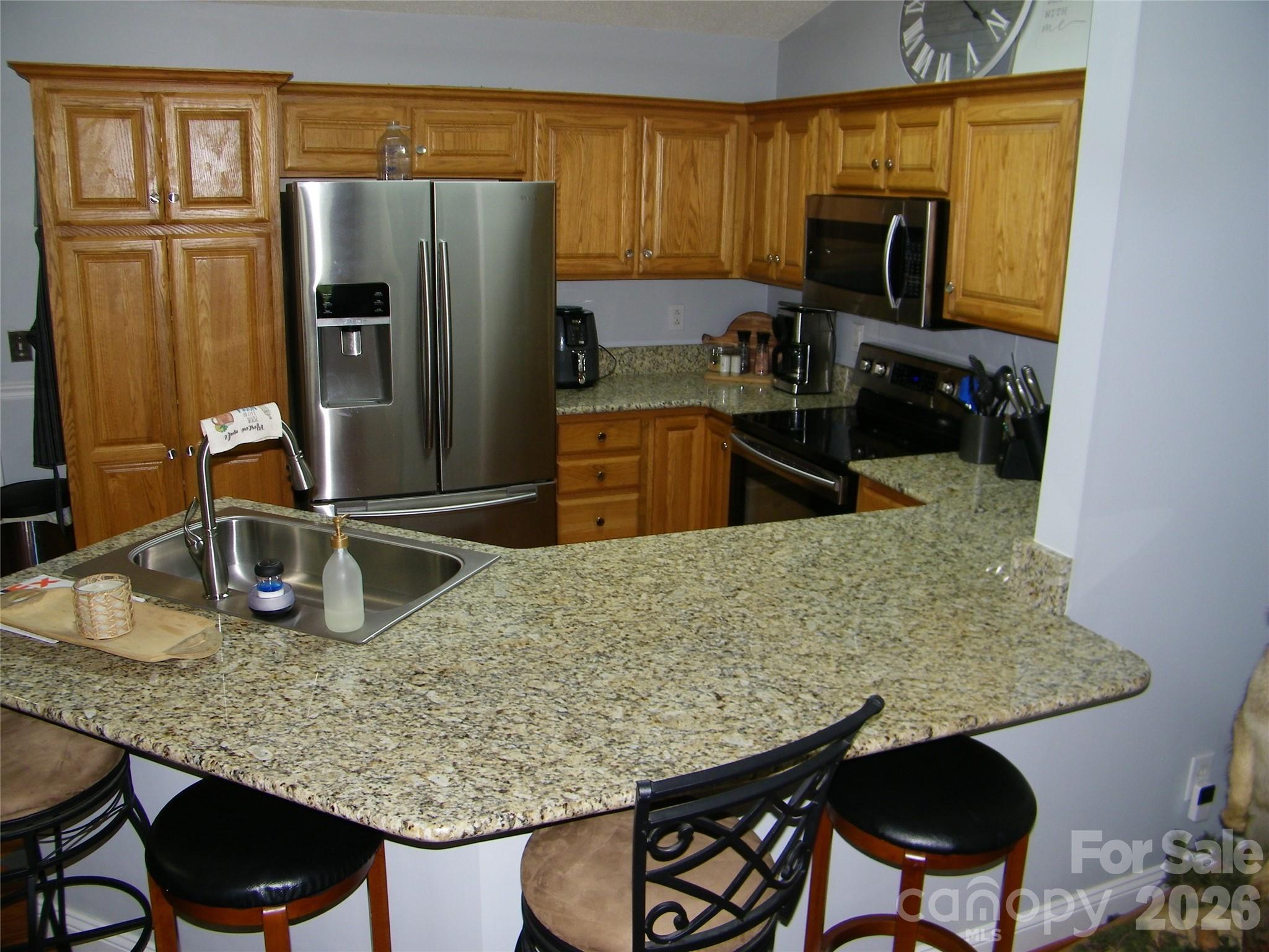 609 Redah Avenue Locust, NC 28097 - Photo 6 of 37 a kitchen with kitchen island a counter top space appliances and a refrigerator