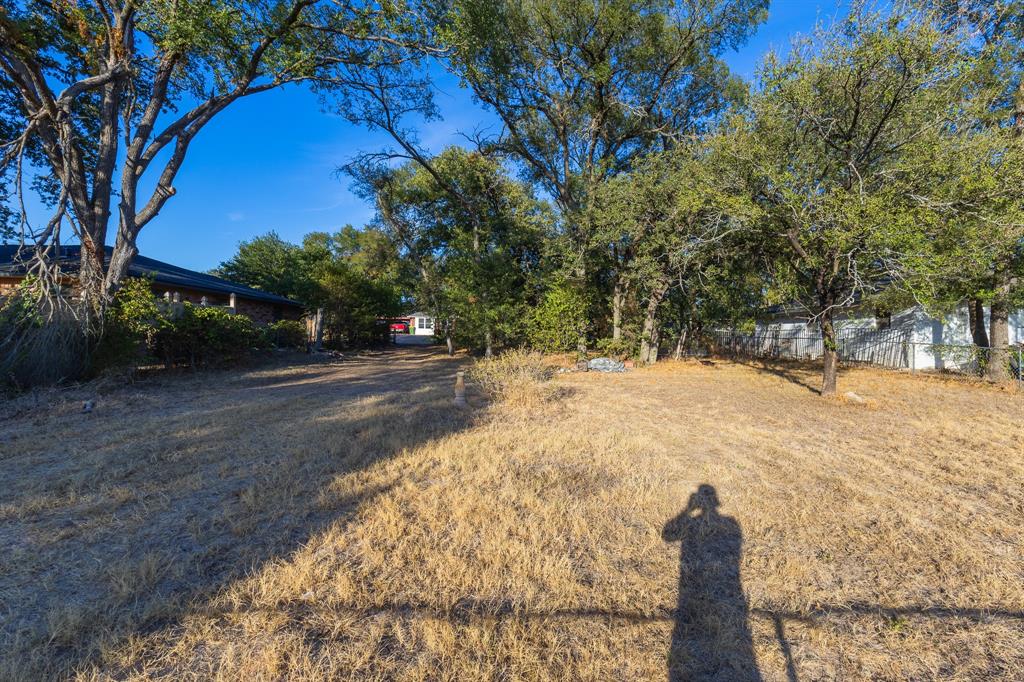 1122 Timberline Street Bellmead, TX 76705 - Photo 19 of 28 Expansive outdoor space featuring mature trees and a sloped terrain