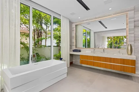 a living room with furniture a window and a flat screen tv