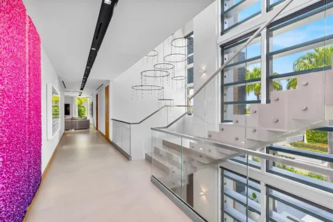 a living room with furniture a rug and kitchen view