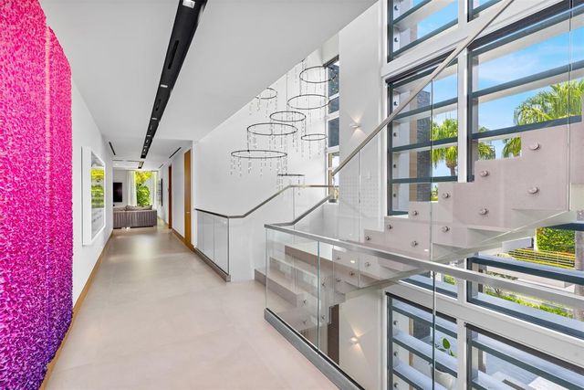 a living room with furniture a rug and kitchen view