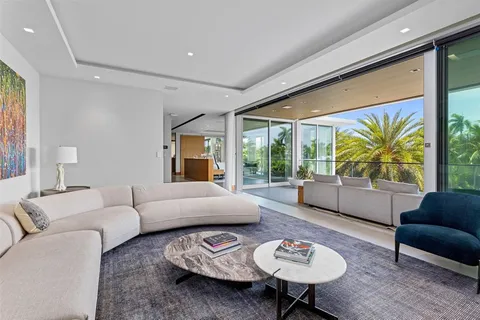 a living room with furniture a dining table and a potted plant