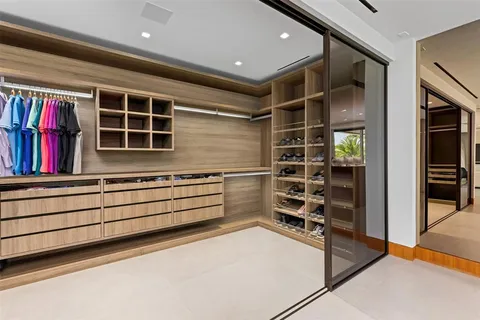 a view of a building with potted plants and palm trees