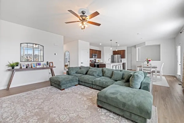 a living room with furniture and kitchen view