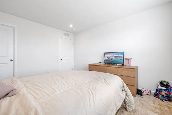 a bedroom with a bed and a tv