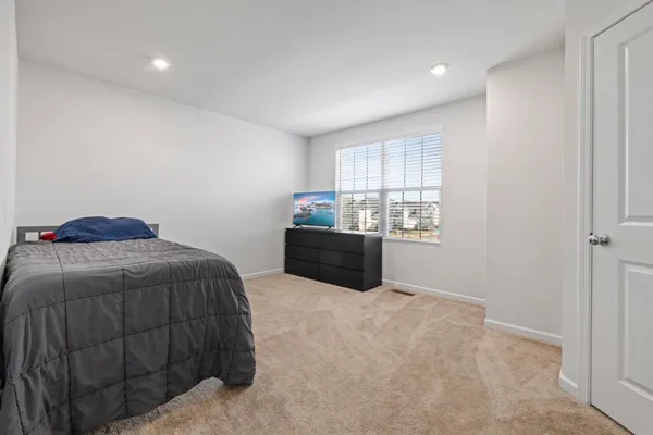 a bedroom with a bed and window
