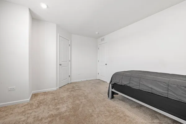 a room with a bed and a dresser