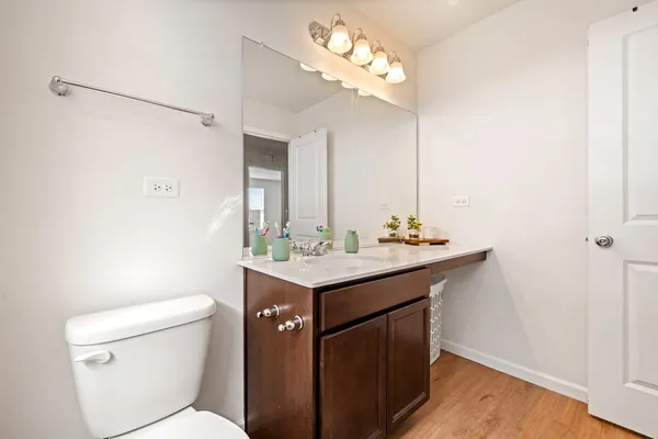 a bathroom with a sink a toilet and mirror
