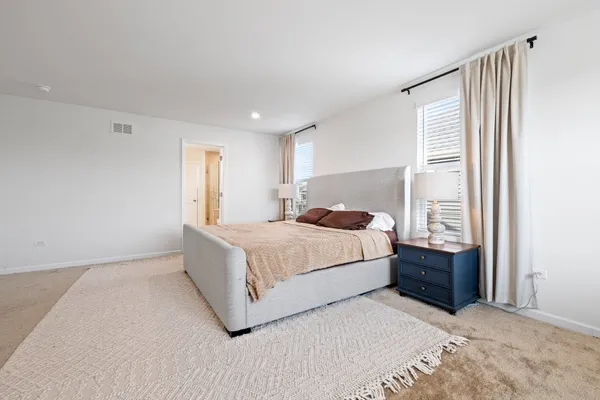 a bedroom with a large bed and a window