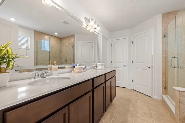 a bathroom with a double vanity sink and a mirror