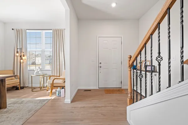 a view of a hallway with wooden floor and windows