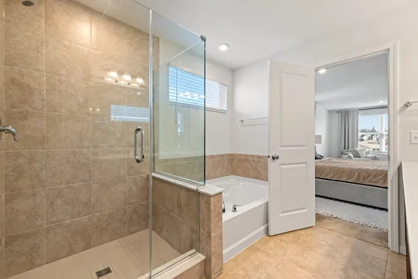 a living room with furniture and a glass door shower