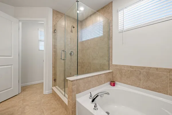 a bathroom with a tub and a shower