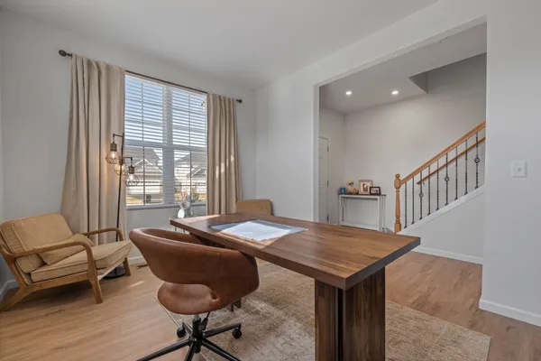 a view of a livingroom with furniture and a window