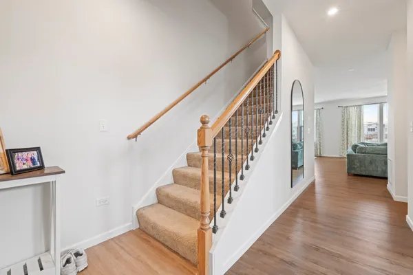 a view of entryway and hall with wooden floor